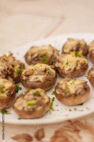 stuffed mushrooms with green mushrooms on a white plate