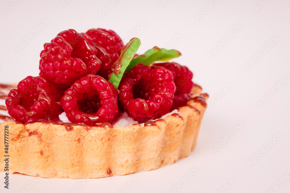 Fresh cake with raspberries in powdered sugar. Dessert in a cafe for breakfast. Fresh cake with raspberries in powdered sugar. Dessert in a cafe for breakfast.