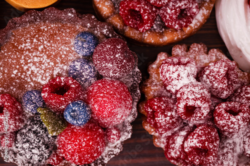 Fresh cake with raspberries in powdered sugar. Dessert in a cafe for breakfast.