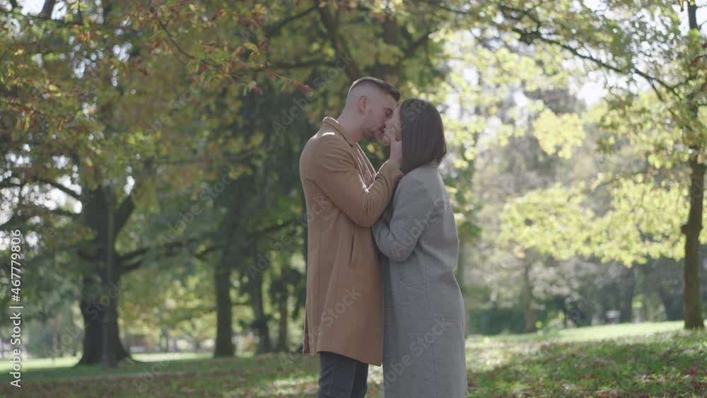 Slow motion - Young couple kissing and hugging in the park Slow motion - Young couple kissing and hugging in the park