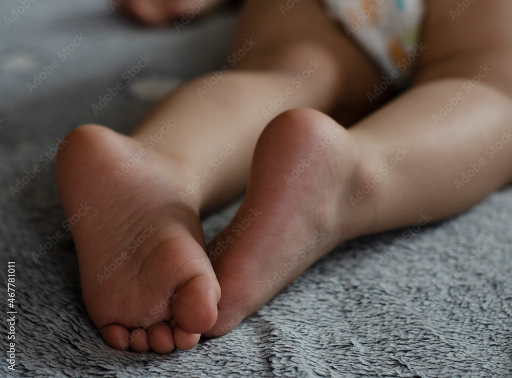 Heel of the baby in a blue fluffy blanket Heel of the baby in a blue fluffy blanket