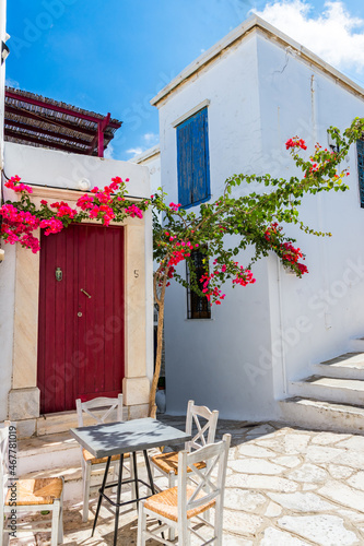 Traditional houses and colourful bougainvillaeas at Tinos island.
