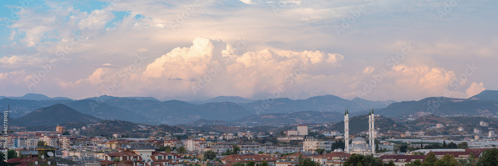 Panorama view over Turkish city with mosque and dramatic sky