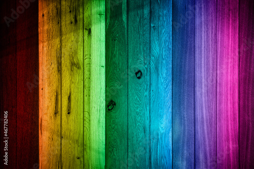 texture from wooden boards of different species in the colors of the spectrum with darkened edges, blurred image
