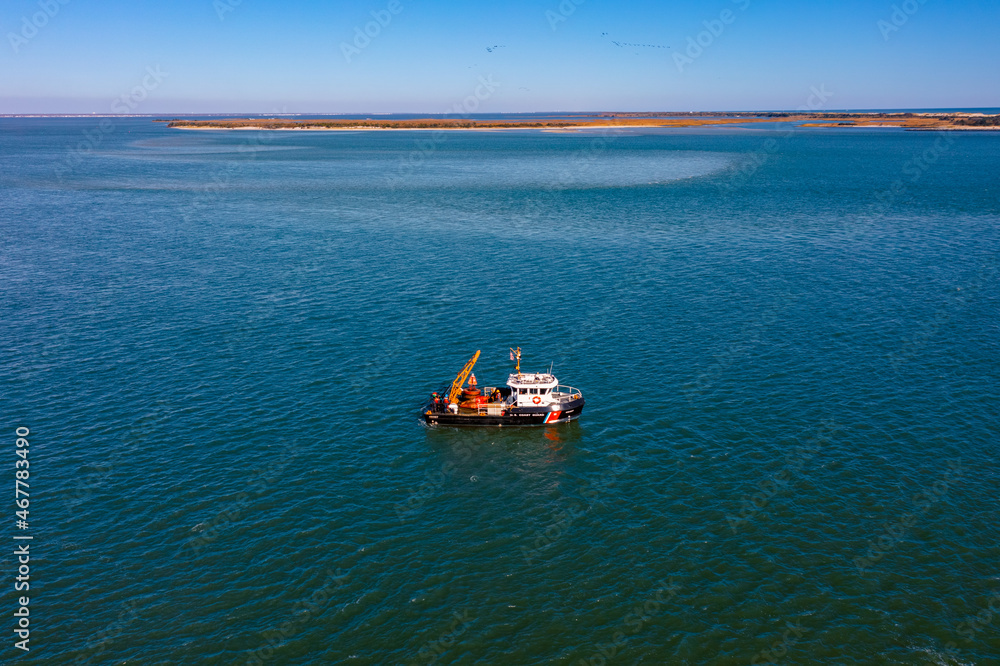 aerial image of a coast guard buoy tender aerial image of a coast guard buoy tender