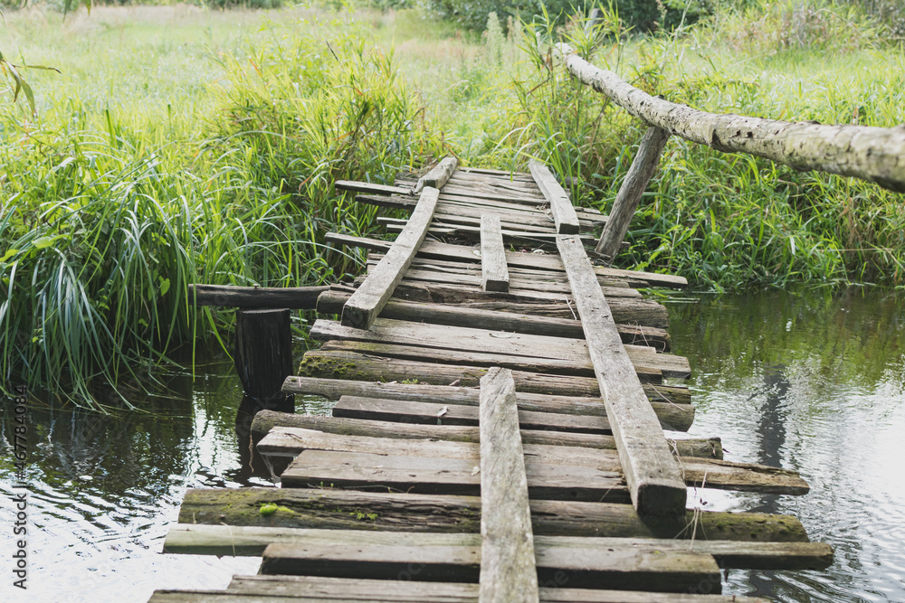 An old wooden bridge across the river An old wooden bridge across the river
