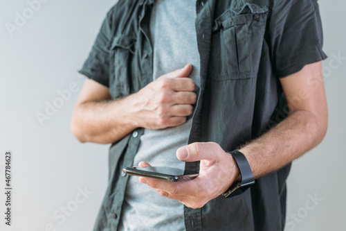Casual man using smart mobile phone for communication