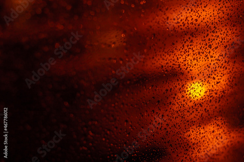 Drops on the glass with lights in the form of bokeh