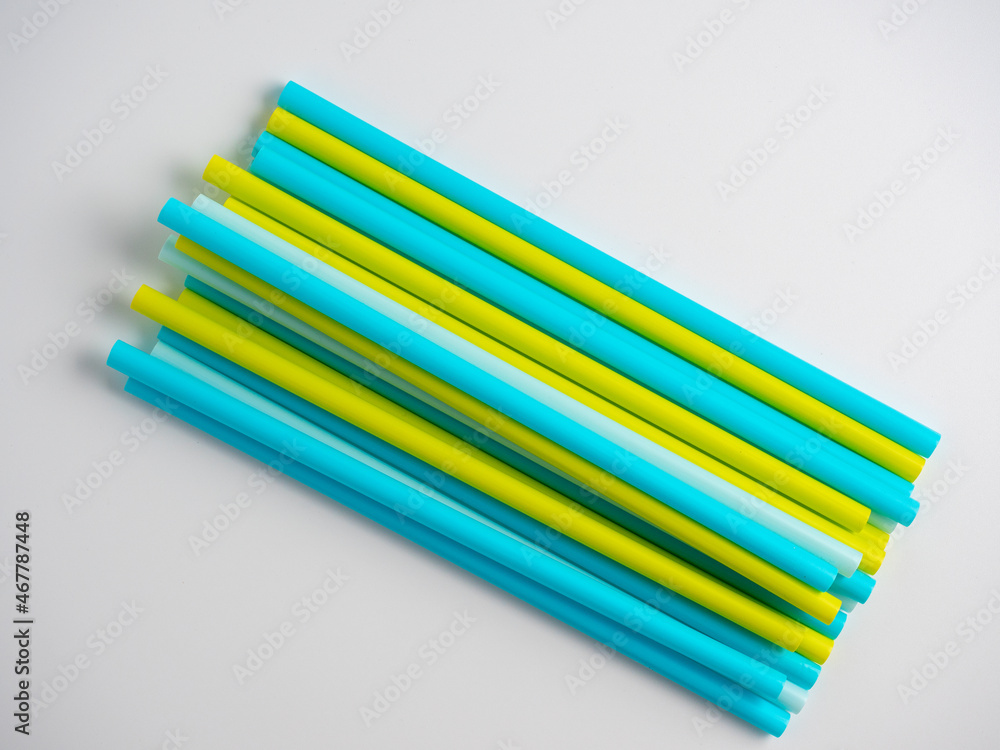 a lot of colorful plastic tubes on a white background. Top view, flat lay a lot of colorful plastic tubes on a white background. Top view, flat lay