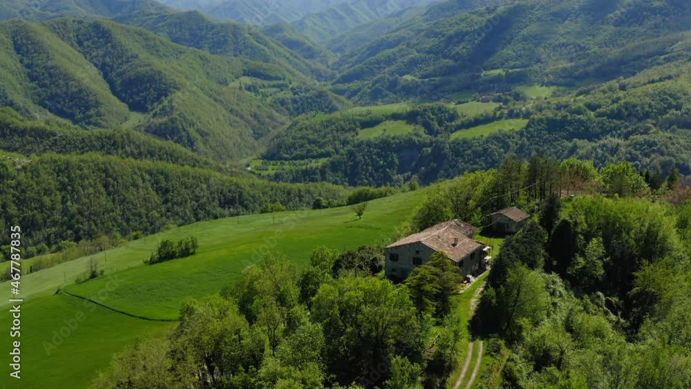 Aerial Beautiful Shot Of Houses On Hilltop, Drone Flying Over Green Landscape During Sunny Day - Apennine Mountains, Italy Aerial Beautiful Shot Of Houses On Hilltop, Drone Flying Over Green Landscape During Sunny Day - Apennine Mountains, Italy