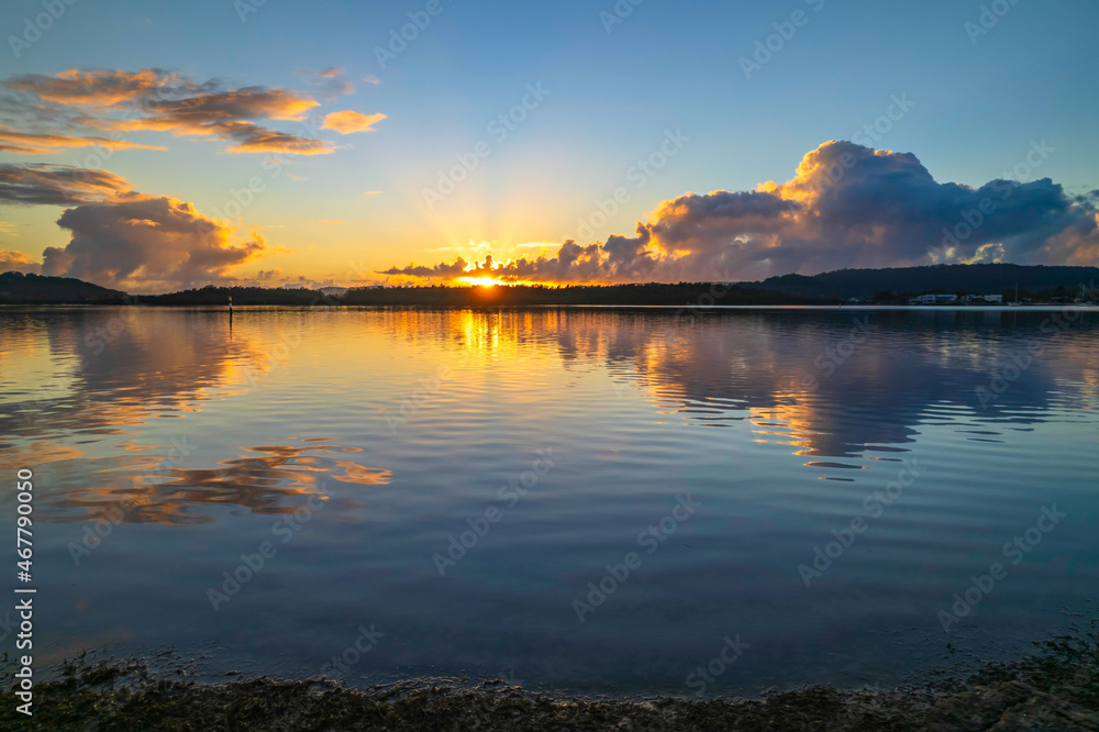 Aerial sunrise over the bay with clouds and reflections