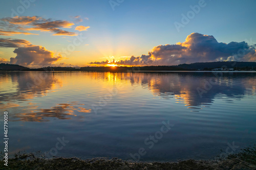 Aerial sunrise over the bay with clouds and reflections