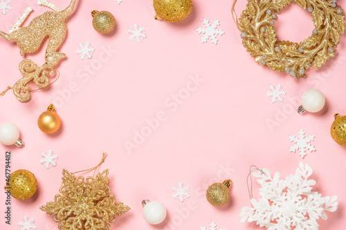 Christmas decorations at pink background. White and golden christmas decorations top view.