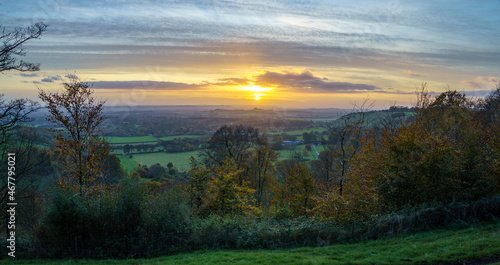 scenic Westerly view as the golden sun sets over Oare and across the Pewsey Vale valley, North Wessex Downs AONB