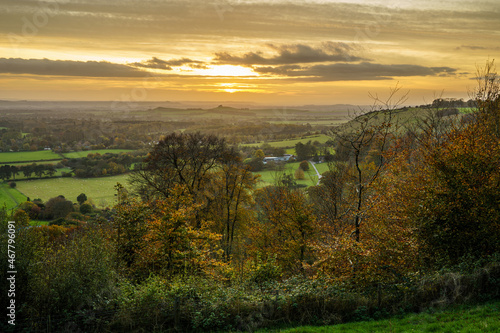 dramatic golden sky and view as the sun sets over Oare village and across Pewsey Vale valley, Marlborough, North Wessex Downs AONB