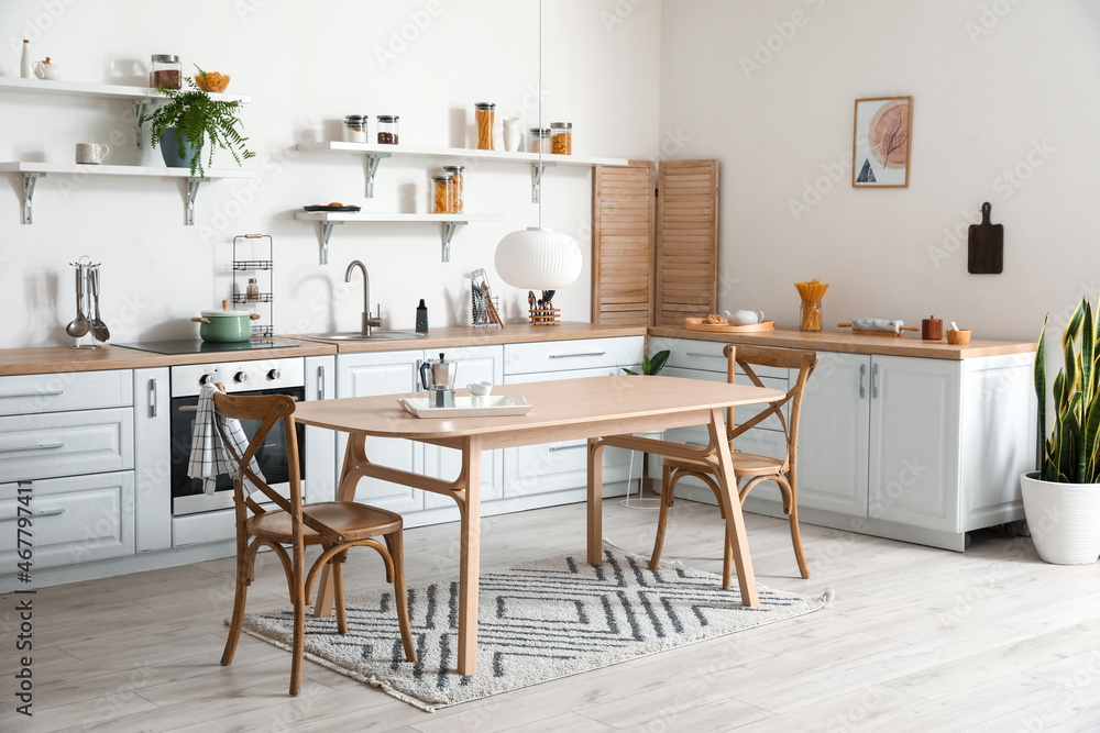 Stylish kitchen interior with wooden dining table Stylish kitchen interior with wooden dining table