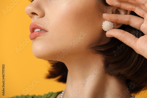 Woman touching elegant earr...