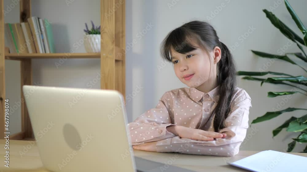 Kid girl school pupil studying online from home watching web class lesson or listening tutor by video call. Online elearning, remote education. Kid girl school pupil studying online from home watching web class lesson or listening tutor by video call. Online elearning, remote education.