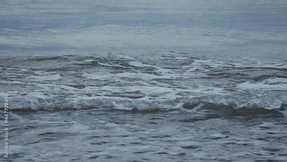 The Waves Beat Against The Sand. Waves Slow Motion. Sea Waves Rolling At Sunrise. Natural sea background for design. Slow Motion Footage of Sea Waves with white Foam. The Waves Beat Against The Sand. Waves Slow Motion. Sea Waves Rolling At Sunrise. Natural sea background for design. Slow Motion Footage of Sea Waves with white Foam.