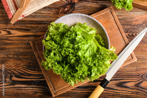 Konstfotografi Bowl with fresh lettuce on wooden background