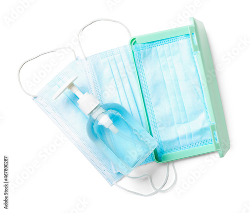 Medical masks with case and sanitizer on white background