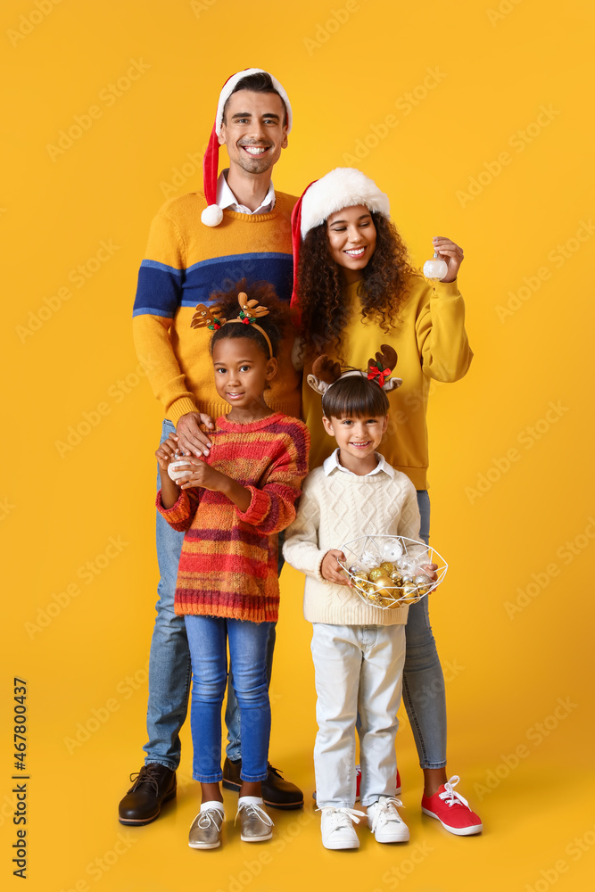 Happy family in Christmas clothes on yellow background