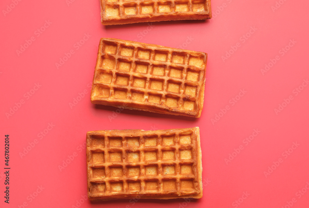 Delicious golden Belgian waffles on color background Delicious golden Belgian waffles on color background