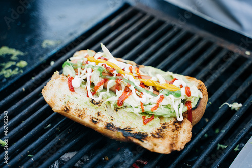 Delicious Traditional Guatemalan Hot Dog called Shuco on grill photo