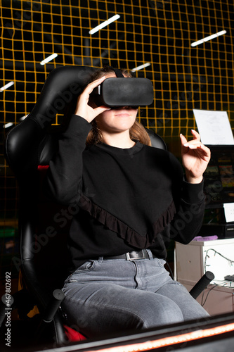 Model wearing vr glasses and something in the game. 3D technologies. Reality glasses photo