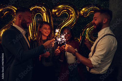 Happy group of friends celebrate New Year's Eve in a club