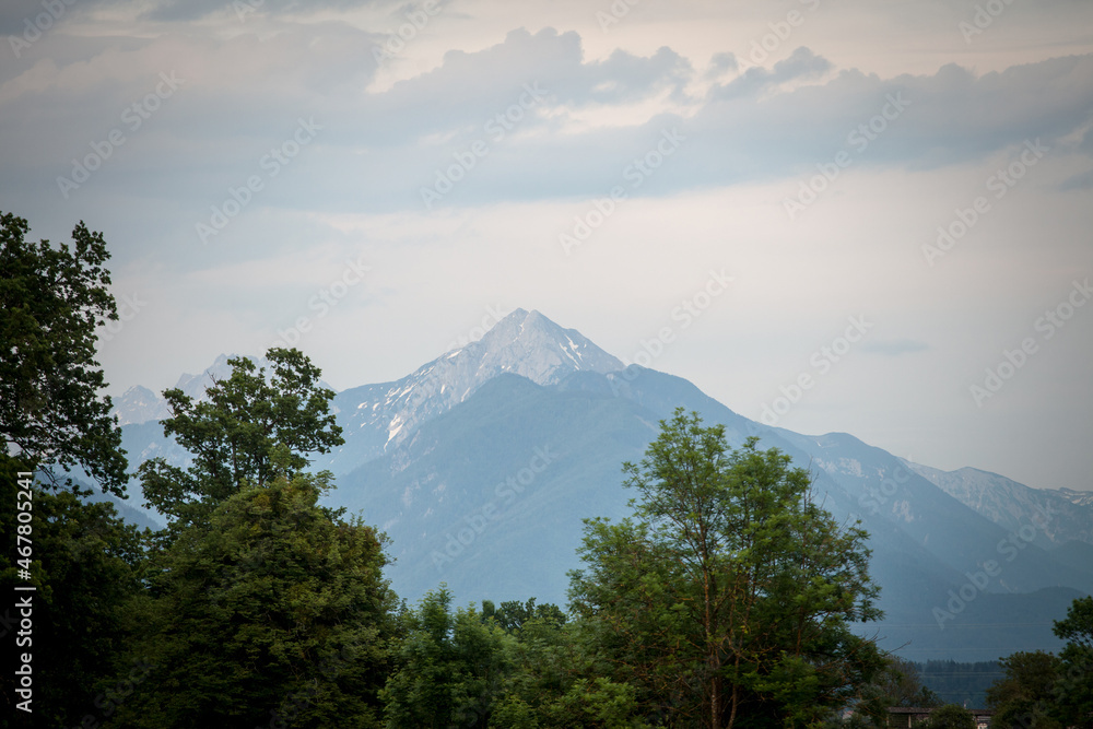 Panorama of the Hochstuhl mount, also called Veliki Stol vrh, between Slovenia and Austria, during a sunset, summit above clouds. It is a major mountain of the Julian Alps, in the karawanks chain..... Panorama of the Hochstuhl mount, also called Veliki Stol vrh, between Slovenia and Austria, during a sunset, summit above clouds. It is a major mountain of the Julian Alps, in the karawanks chain.....