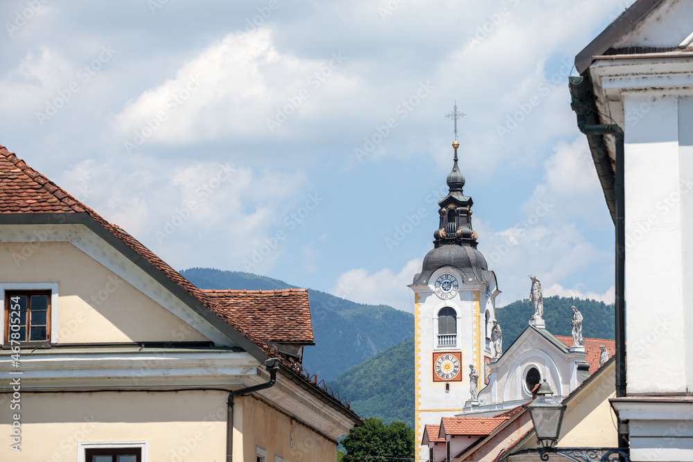 Church tower, cerkveni stolp, on the Zupnijska cerkev, a baroque roman catholic church in the center of Kamnik, Slovenia, on the main street of the city, Sutna, in a sunny summer afternoon.....