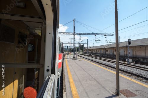 Train station platform of Pivka, slovenia, seen from the window of a passenger train travelling accross europe during a sunny summer afternoon. Slovenian railways are a major rail hub. .. photo