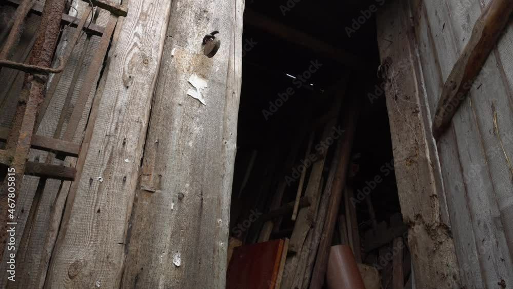 The hand opens the door to the old abandoned barn, the gate to the ominous barn opens The hand opens the door to the old abandoned barn, the gate to the ominous barn opens