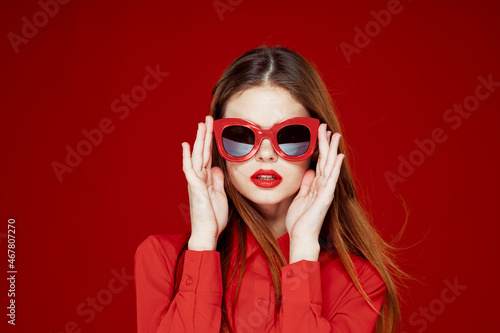 cheerful woman in a red shirt sunglasses Glamor close-up