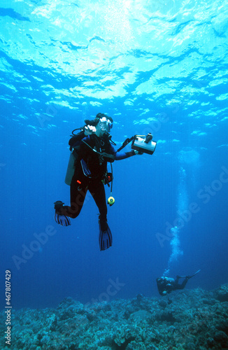  A Hawaiian Tropical Scuba Diver Woman with a Video Camera Ascending After a Successful Dive