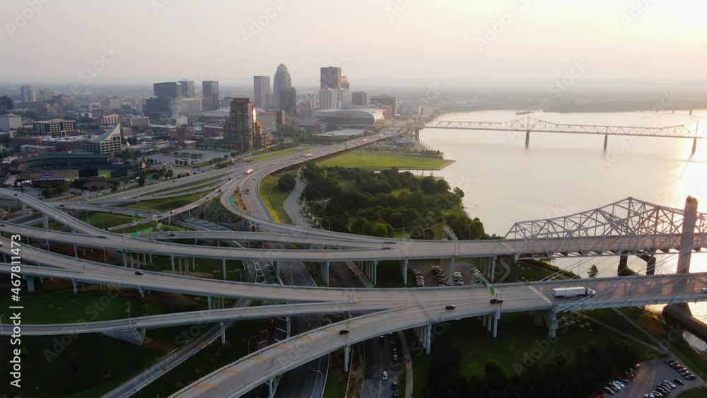 Aerial view overlooking the bridges and the cityscape of Louisville, sunset in Kentucky, USA - pan, drone shot Aerial view overlooking the bridges and the cityscape of Louisville, sunset in Kentucky, USA - pan, drone shot