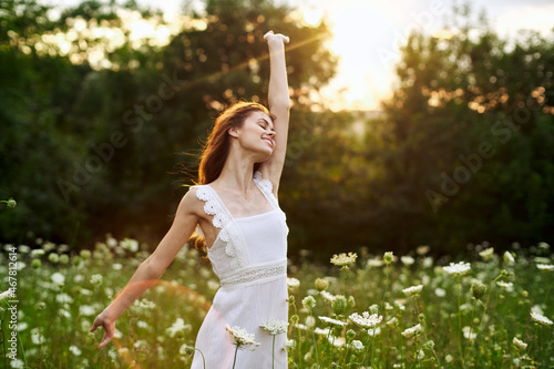 Woman in white dress in a field flowers sun nature freedom
