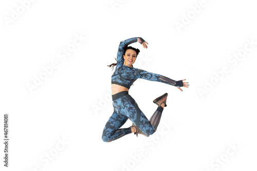 Beautiful sporty woman in a blue camouflage tracksuit is engaged in fitness. Jumping posing over isolated white background. Smiling and looking at the camera. Sports and healthy lifestyle
