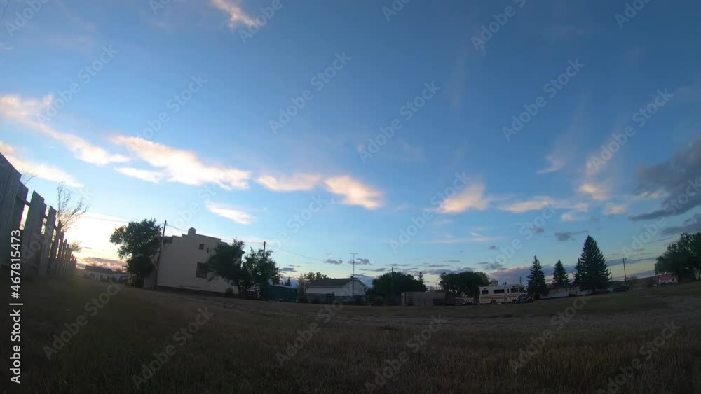 TIMELAPSE - View of the clouds traveling over some buildings across from a field during the daytime in Empress Alberta Canada. TIMELAPSE - View of the clouds traveling over some buildings across from a field during the daytime in Empress Alberta Canada.