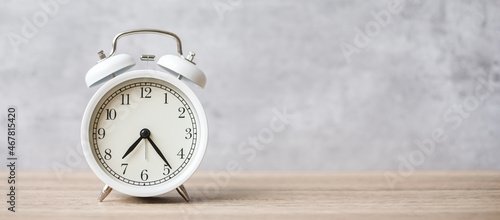 Vintage alarm clock on wooden table background and copy space for text. Activity, daily routine, morning, countdown, workout and Work life balance concept