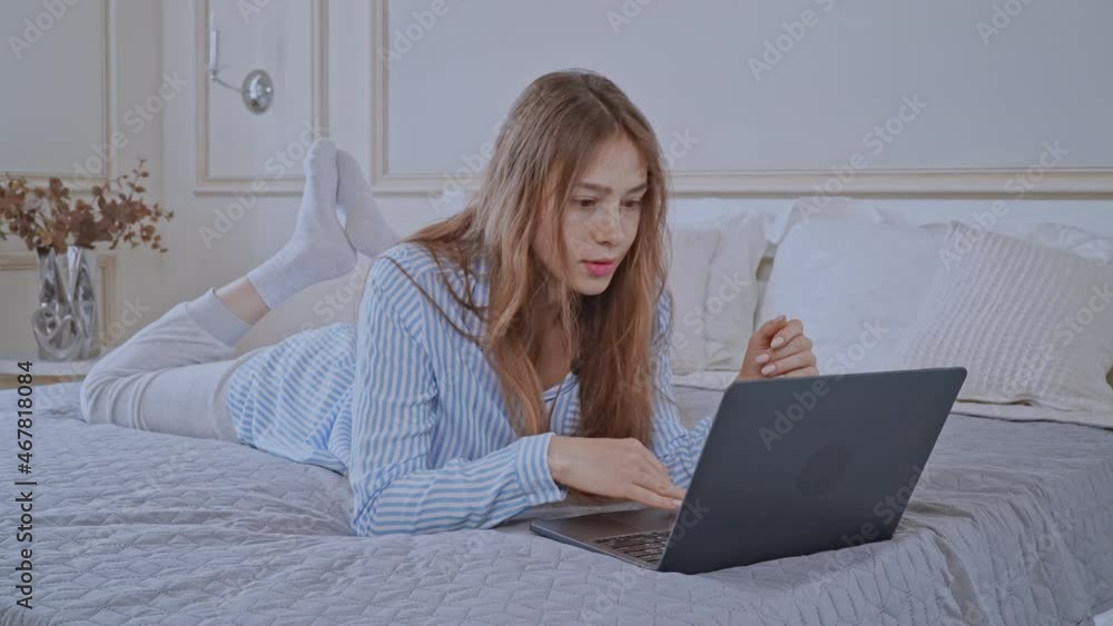 caucasian female using computer in bedroom caucasian female using computer in bedroom