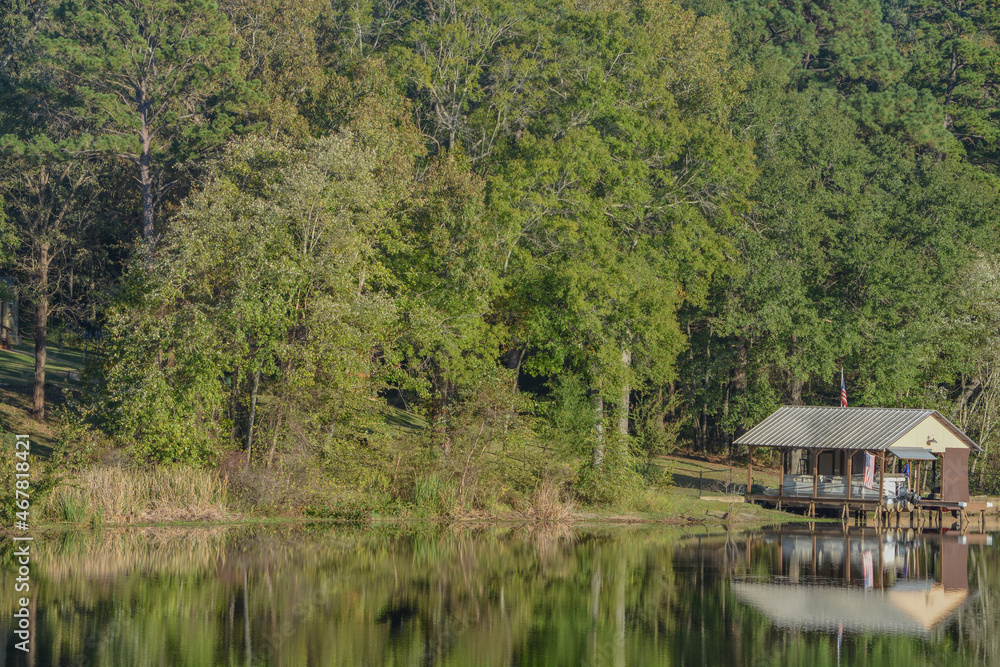 Mirror Image on Lake Cherokee of boat houses and trees. In East Henderson, Rusk County, Texas