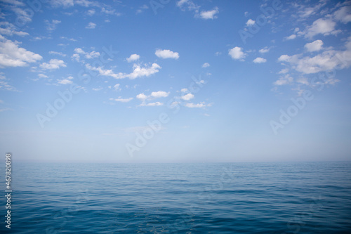 Blue sea and sky with white clouds