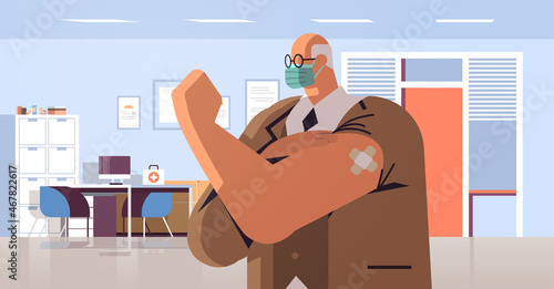 vaccinated man after vaccine injection successful covid-19 vaccination concept hospital clinic interior