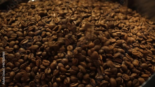 Close up shot of coffee beans are falling on each other different speads. photo