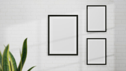 Modern poster frames mockup interior on white wall with minimal house plant