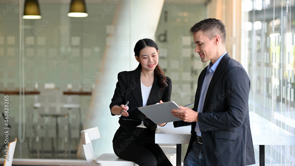Female accountant explain accounting plans on digital tablet to her boss. Female accountant explain accounting plans on digital tablet to her boss.