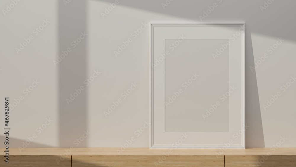 White portrait poster frame mockup standing on wooden table with copy space White portrait poster frame mockup standing on wooden table with copy space