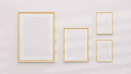 Mockup of multiple minimal wooden picture poster frames on a white wall